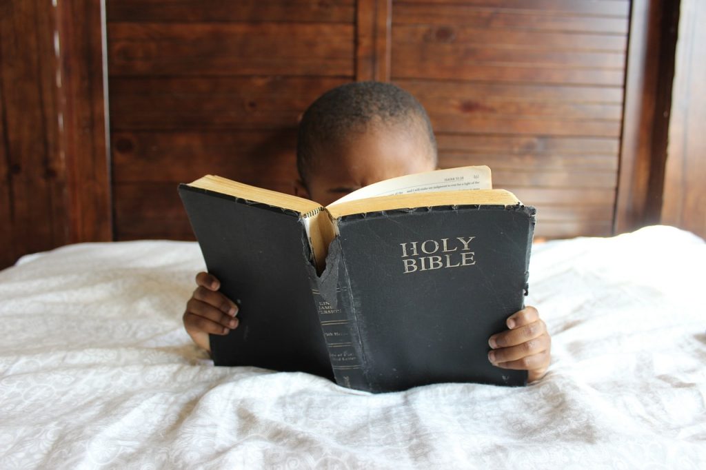 child reading a bible