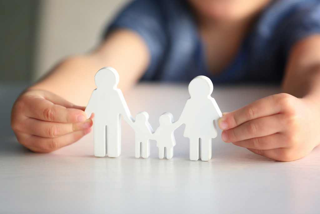 a cutout of a family being held by a child