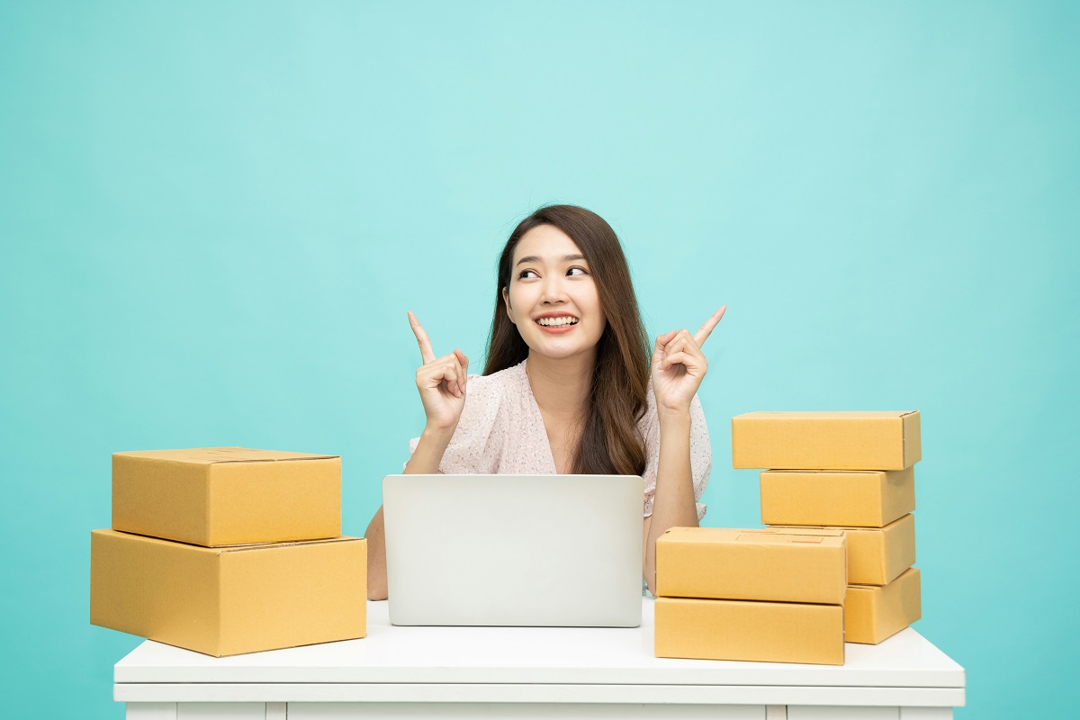 entrepreneur sitting at a desk with cardboard boxes